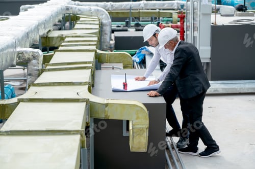 Preview: Two engineer as young and senior worker discuss about project using building plan or drawing