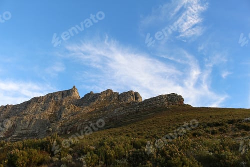 Preview: Beautiful Green hill and rocky hill against blue cloudy sky. Forest, nature