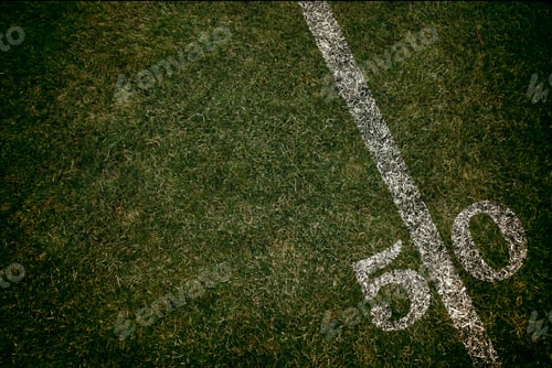 Preview: Football field ground fifty yard line. Friday night lights.