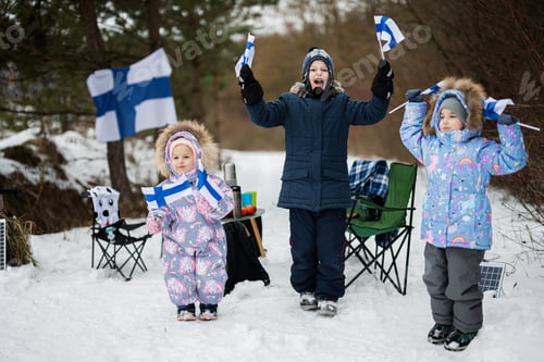 Preview: Three finnish children with Finland flags on a nice winter day. Nordic Scandinavian people.
