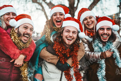 Preview: Happy friends wearing santa claus hat celebrating Christmas eve together