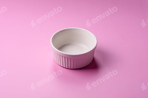 Preview: An empty round ceramic plate on a pink background as a kitchen utensil. An empty plate