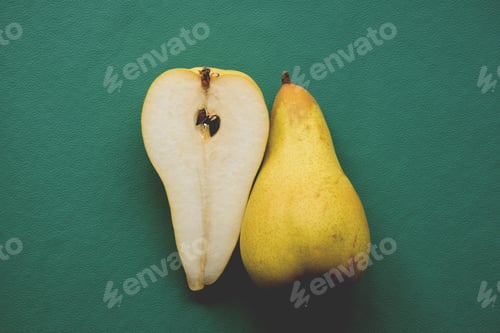Preview: Minimal shot of two pears on dark green background
