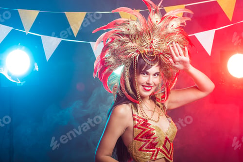 Preview: Carnival, belly dance and holiday concept - Beautiful female samba dancer wearing gold costume and