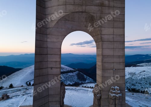 Preview: Beautiful aerial view of snow covered mountains and the Monument Arch of Liberty at the main ridge