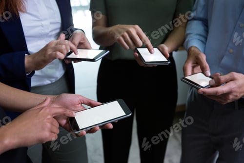 Preview: Executives using mobile phone in the office