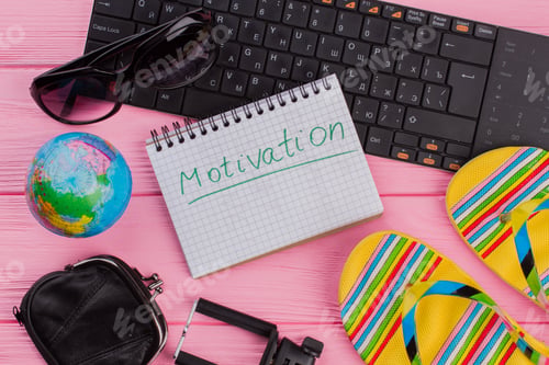 Preview: Motivation on notebook with woman's traveler accessories.