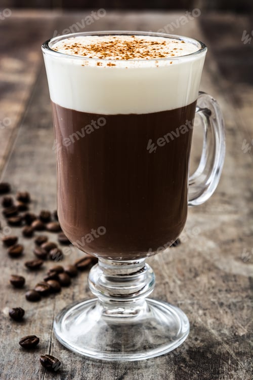 Preview: Irish coffee with whipped cream and cinnamon on rustic wooden table