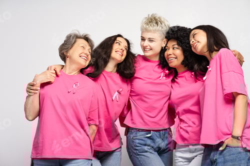 Preview: Diverse group of happy women embracing and smiling, showing support for breast cancer awareness