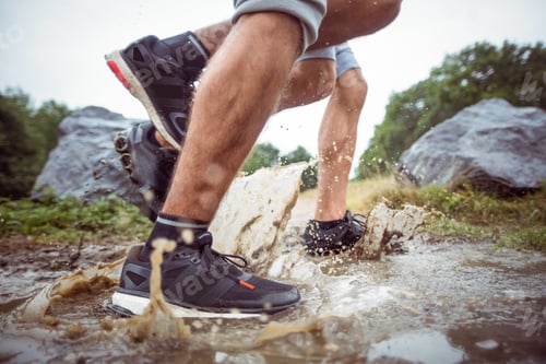 Preview: Men walking in muddy puddles in the countryside