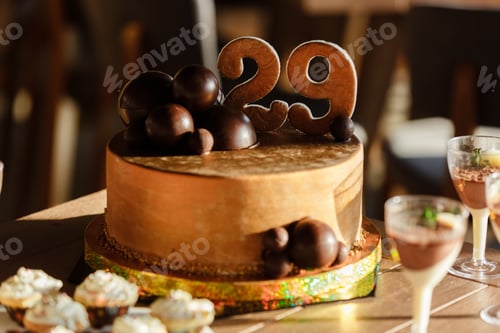 Preview: Candy Bar. Delicious sweet buffet with brown birthday cake decorated chocolate balls and number