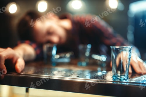 Preview: Drunk man sleeps at bar counter, alcohol addiction