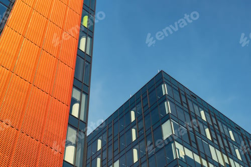 Preview: Modern office building exterior with glass facade on clear sky background. Transparent glass wall of