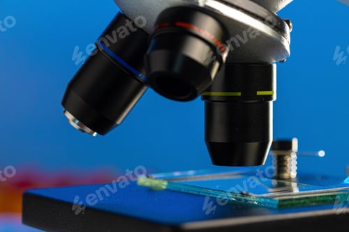 Preview: Close up photo of a microscope lenses examining glass sample