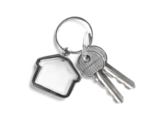 Preview: House keys with trinket on white background, top view