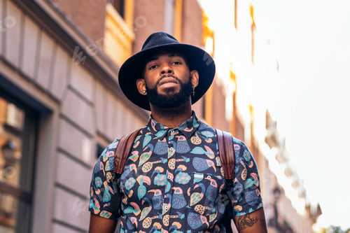 Preview: Stylish black man walking on the city street