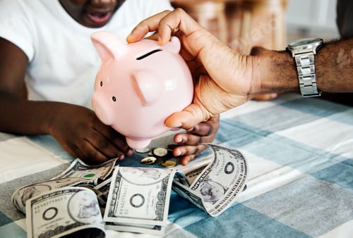 Preview: Dad and daughter saving money to piggy bank