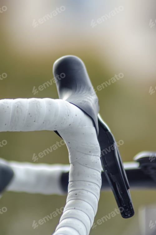 Preview: selective focus, detail of the handlebars of a road racing bike. Cycling concept