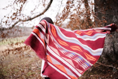 Preview: Woman with cozy blanket in fall