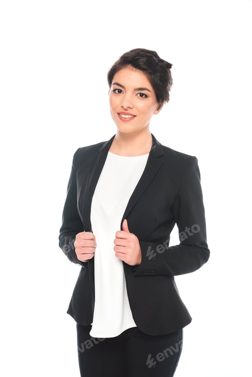 Preview: attractive mixed race businesswoman in formal wear smiling at camera isolated on white