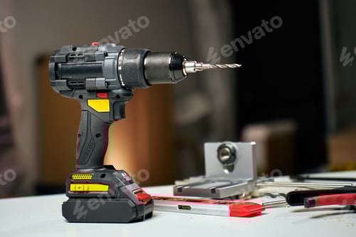Preview: Cordless drill and tools in home renovation workshop