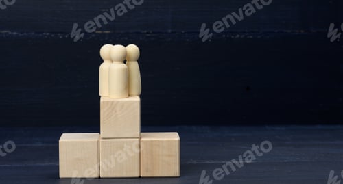 Preview: Wooden figurines on top of the pyramid. The concept of well-coordinated teamwork, achieving goals