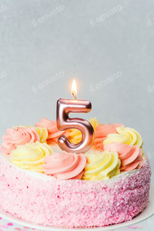 Preview: Birthday cake with pink and yellow frosting for a fifth birthday celebration