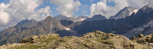 Preview: Panoramic View of Majestic Mountain Range with Rocky Foreground