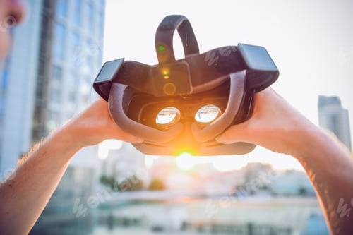 Preview: VR Goggles. Man ready to wear virtual reality goggles. The vr headset design is generic and no logos