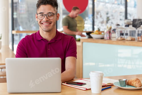 Preview: Photo of happy youngster with transparent glasses, pleasant smile, keyboards information, works remo