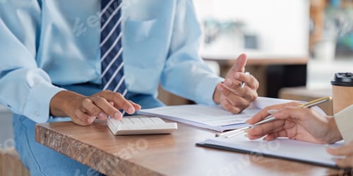 Preview: Bookkeeper Engaging in Detailed Financial Planning at Cafe Table