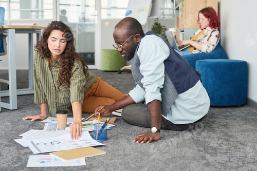 Preview: Young brunette businesswoman taking one of financial documents