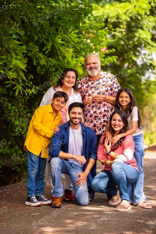 Preview: Indian family bonding happily while standing outdoors and smiling together