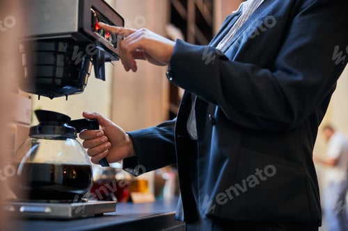Preview: Close up of young woman that standing near coffee-machine