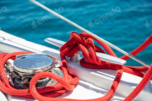 Preview: Sailing boat mooring rope tied on cleat. Heavy metal chain around the winch