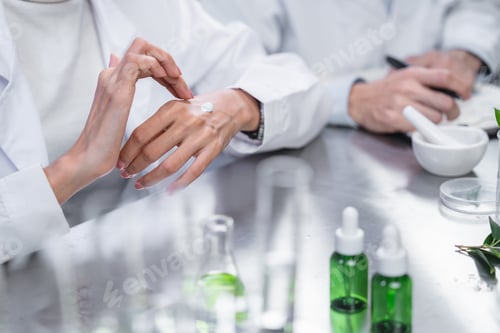 Preview: Beauty eco cosmetic research and development concept, Pharmacist applying moisturizer lotion