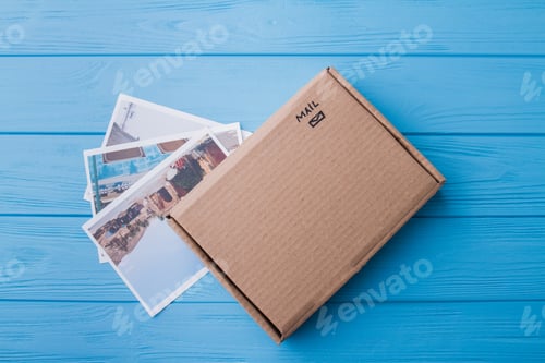 Preview: Flat lay, carton sending mail package and vacation photos.