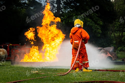 Preview: Firefighter Concept. Fireman using water and extinguisher to fighting with fire flame.