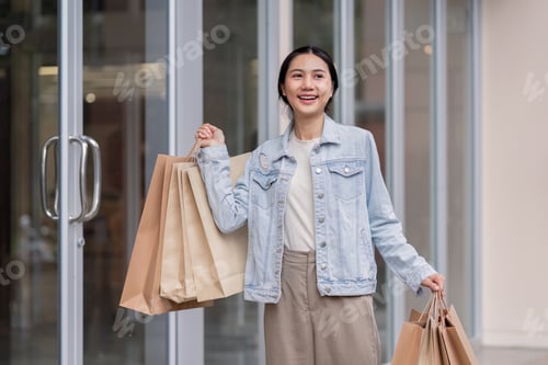 Preview: Young Shopper Experiencing Joy with Shopping Bags Outdoors