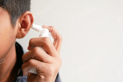 Preview: Close up of men using spray to remove earwax