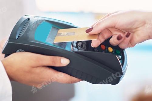 Preview: Tap and go. Cropped shot of a customer using her credit card to make a payment.