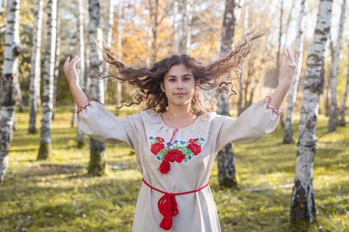 Preview: beautiful woman in ukrainian national traditional costume clothes in forest