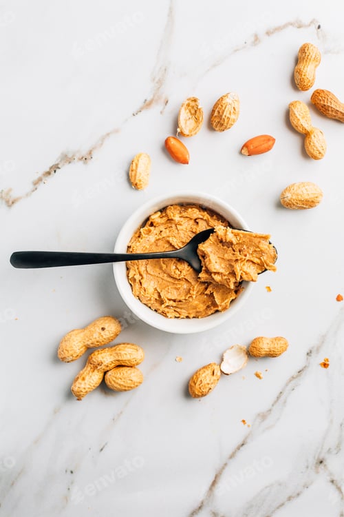 Preview: Bowl with homemade crunchy peanut butter and heap of nuts