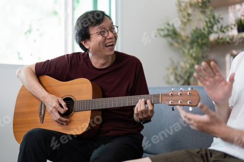 Preview: Father playing guitar and sharing laughter with son