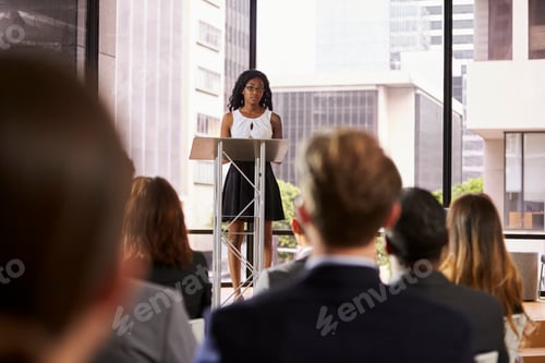 Preview: Young black woman at lectern presenting seminar to audience