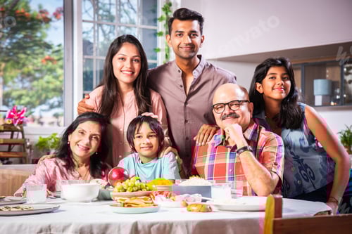 Preview: Happy Indian asian family having lunch at home and posing for photo
