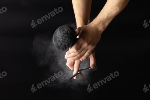 Preview: barber is holding a brush for powder hairdresser and scissor