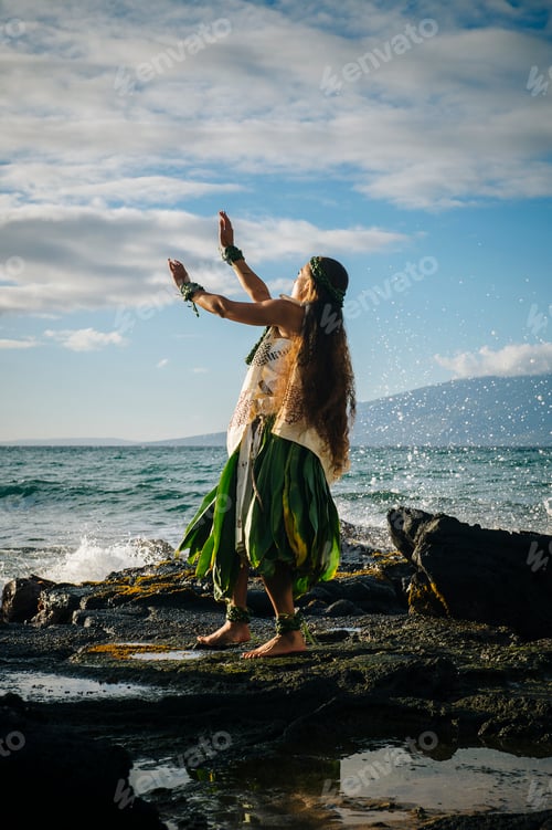Preview: Young woman hula dancing on coastal rocks wearing traditional costume, Maui, Hawaii, USA