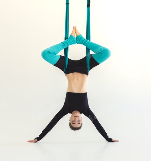 Preview: Woman practicing fly yoga over white background
