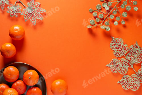 Preview: Chinese or lunar new year flat lay with plate of mandarins and flowers on orange